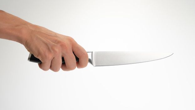 Kitchen knife in the right hand of a woman on a white background. High quality photo
