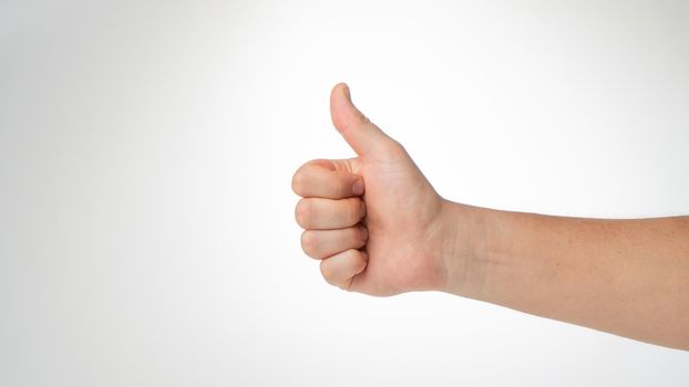 Men's hand thumbs up gesture like, cool. High quality photo