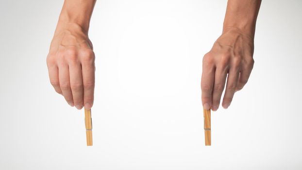 woman's hands on top hold clothespins to fasten the background for the inscription. High quality photo