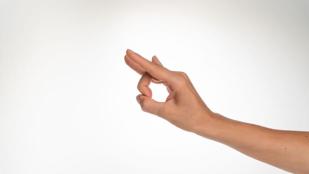 Female hand gesture clicking on forehead on white background. High quality photo