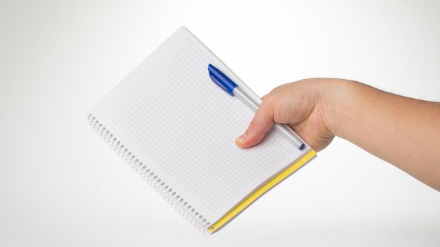 A man's right hand holds a pen and notebook space for inscription. High quality photo