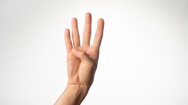 Women's hands gesture counting on fingers 4 palm side. High quality photo