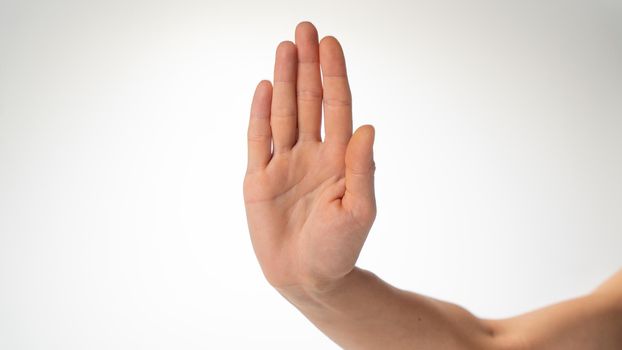 woman's hand gesture stop on a white background. High quality photo