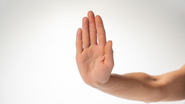 woman's hand gesture stop on a white background. High quality photo