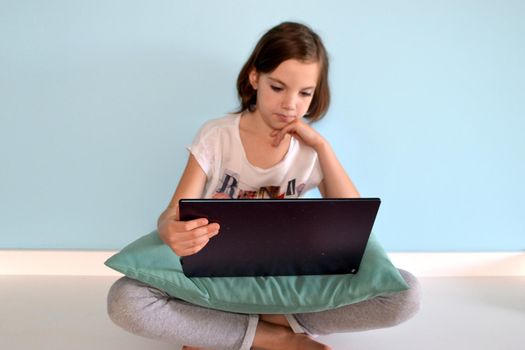 Girl student online learning class study online video call zoom teacher, Happy girl learn english language online with laptop at home. New normal. Social distancing. stay home . High quality photo