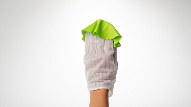 Hand in a hygienic glove removes dirt from the monitor white background