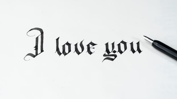 Calligraphy I love you with a fountain pen on a white background declaration of love