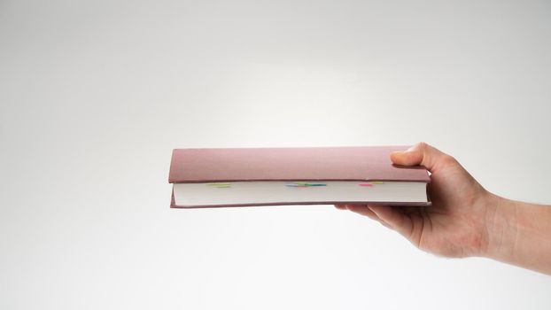 Hand reaches out the book horizontally, the pages are visible. High quality photo
