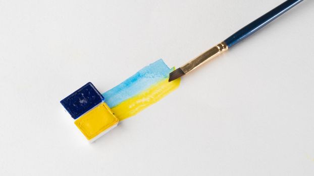 Ukrainian flag in watercolor with a place for writing brushes and paint