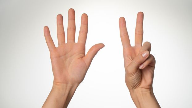 Women's hands gesture counting on fingers 7 palm side. High quality photo