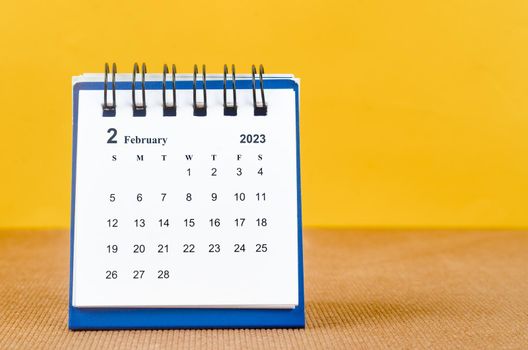 February 2023 Monthly desk calendar for 2023 on yellow background.