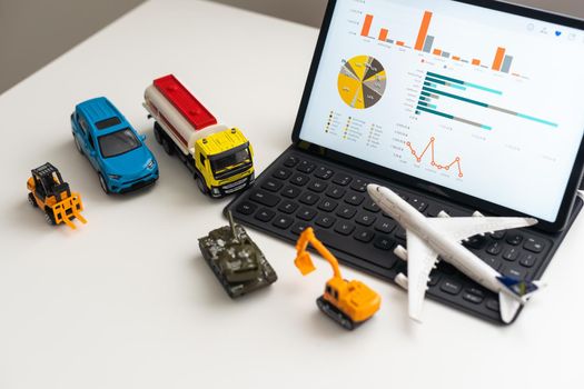 a set of toy vehicles and a tablet.