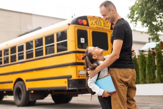 Cute little girl going to school with her father.