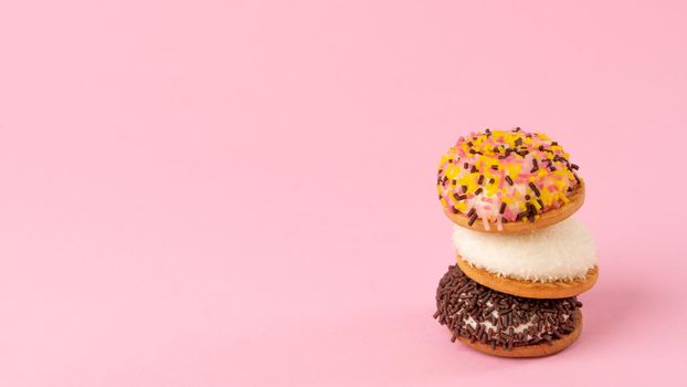 Cakes with decoration for confectionery - pink background with sweets, space for text. High quality photo