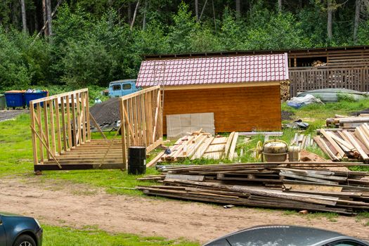 construction of a frame house. Timber frame house, new build roof with wooden home construction framing. wooden roof frame underway. wooden shed, wooden bathhouse