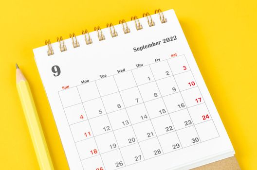 September 2022 Monthly desk calendar for 2022 with pencil on yellow background.