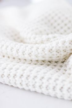 Knitwear, fabric textures and handmade items concept - Warm knitted clothes, soft and white