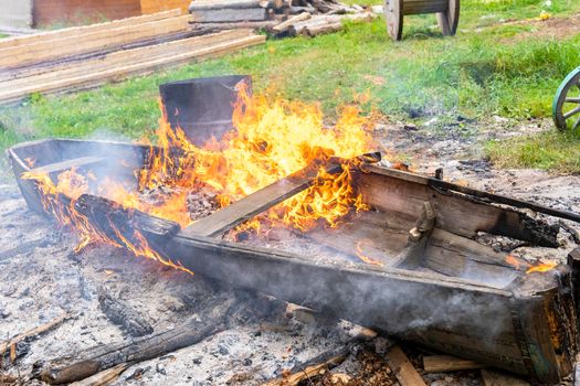 bonfire, an old wooden boat is burning in a bonfire. burning of wooden garbage. fire and conflagration