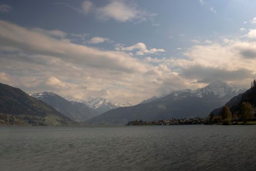 Beautiful landscape showing a big lake surrounded by snowy mountains in Hallstatt Austria