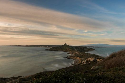 Landscape showing Cape San Marco among water in Sardegna island in Italy in a long exposure picture