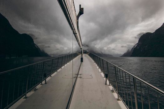 Geirangerfjord reflected in the glass windows of a ferry boat