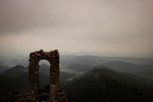 old ruined Queralt castle and mountains surrounding it in Catalonia