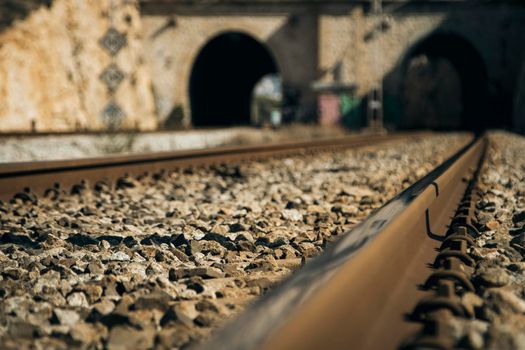 Train rail view to the entrance to a tunnel