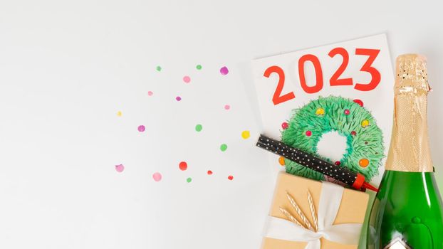 New Year's set - postcard, bottle of champagne, confetti, gift with ribbon, 2023. High quality photo