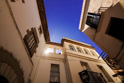 Classic houses and the sun view from below in Sitges Barcelona