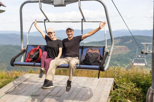 man and woman on the lift in the mountains