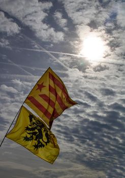 Catalan independence flags under the sun and a cloudy sky