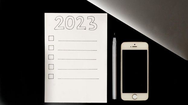 Checklist for the 2023 new year, make a plan on the desktop. High quality photo