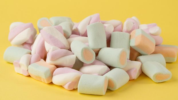 Close-up of marshmallows on a yellow background. High quality photo