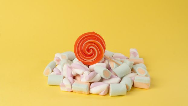 Round multi-colored lollipop in marshmallows, background for a sweet tooth. High quality photo