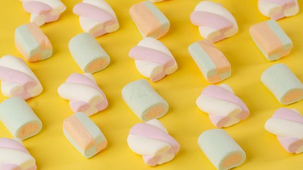 Composition of marshmallows on a yellow background - lines diagonally. High quality photo