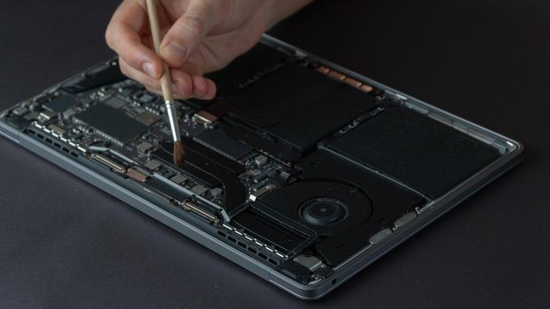 Removal of dust from the laptop, repair and maintenance of computer equipment. High quality photo