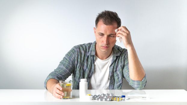 A sick man does not feel well - home treatment of influenza with pills. High quality photo