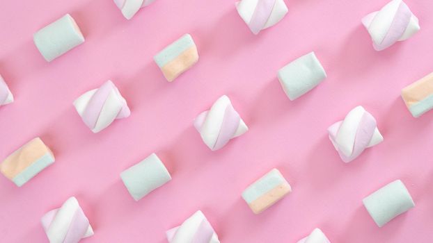 Multicolored marshmallows on a pink background, screensaver, collage. High quality photo