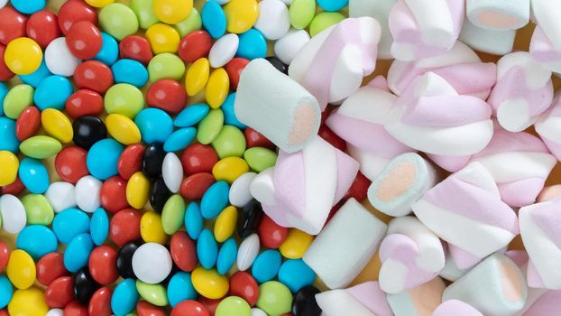 Background of marshmallows and colorful dragees, sweets. High quality photo