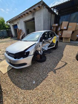 Tbilisi, Georgia - July 26, 2022: Broken gray Volkswagen sedan taxi car. Wrecked taxi car after side collision in parking lot.