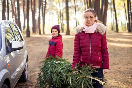 Naughty family with christmas beauty near the car