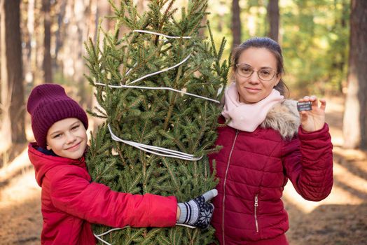 Happy family outdoor on a bright winter day before holidays