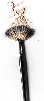 Beauty texture, cosmetic product and art of make-up concept - Brush and beige powder close-up isolated on white background