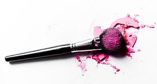 Beauty texture, cosmetic product and art of make-up concept - Brush with crushed eyeshadow and powder close-up isolated on white background