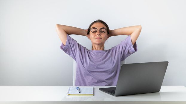 Girl student finished online learning relaxing on a chair. High quality photo