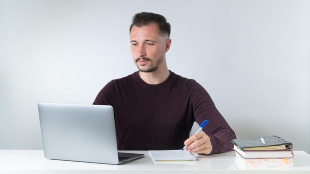 A man works at computers - office, freelancing, online training. High quality photo