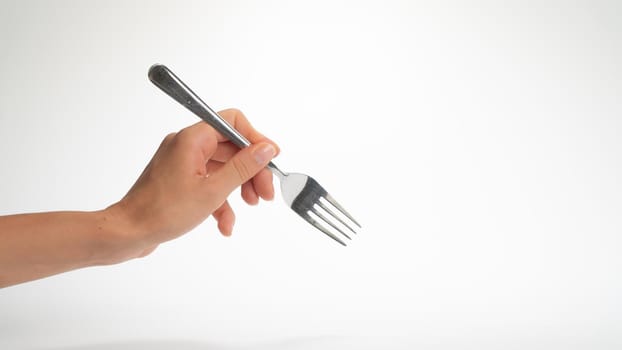 Fork in maiden hand woman gesture to eat on white background. High quality photo