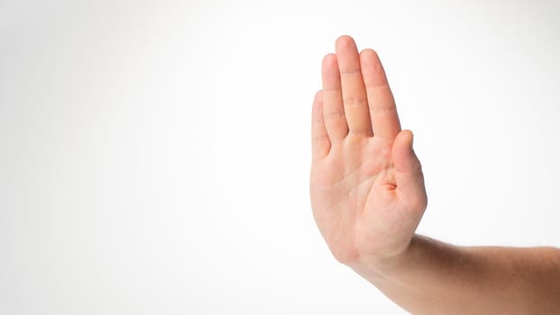 Men's hand gesture stop on a white background. High quality photo