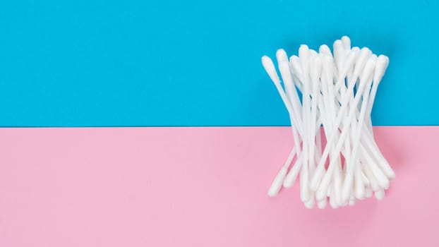 White cotton swabs on a two-tone bright background. High quality photo