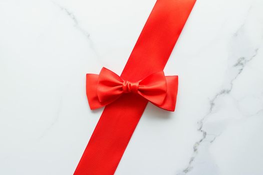 Holiday decor, feminine design and flatlay concept - Red silk ribbon on marble, top view